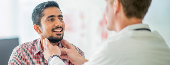 Healthcare provider examining patient's neck