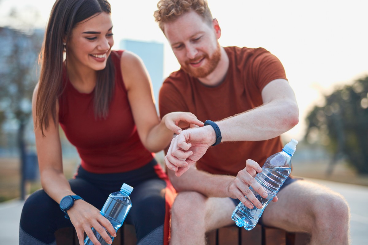 couple making pause in an urban park during jogging