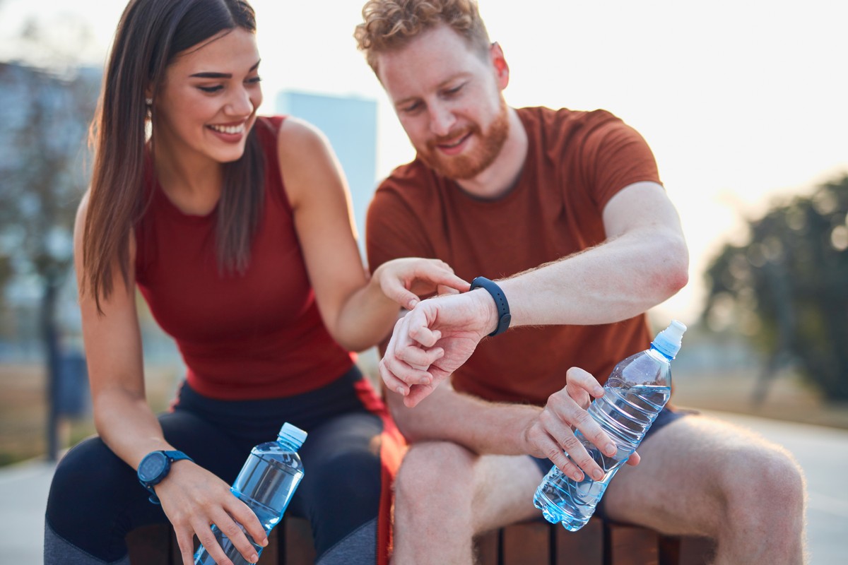 couple making pause in an urban park during jogging