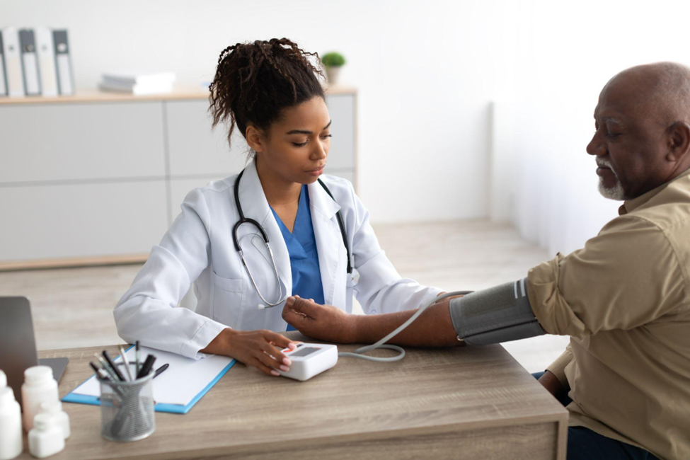 Doctor checking measuring pressure on patient's hand