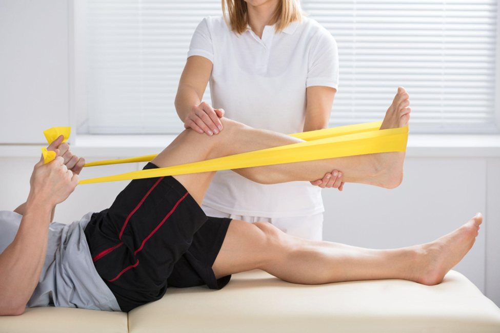 Close-up of a female physiotherapist giving treatment with exercise band