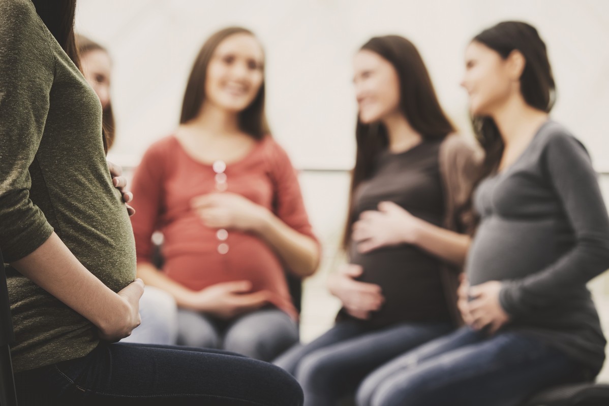 Happy pregnant women are talking together at antenatal class