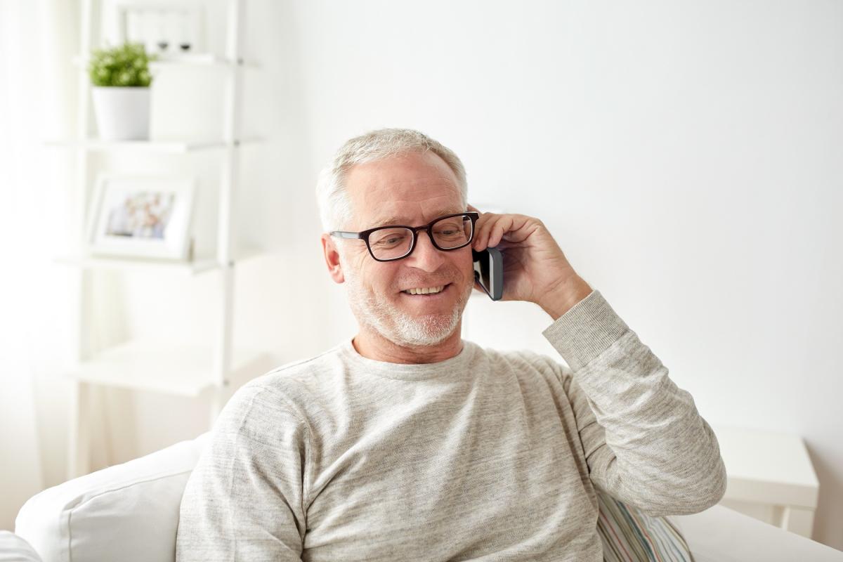 happy senior man calling on smartphone at home