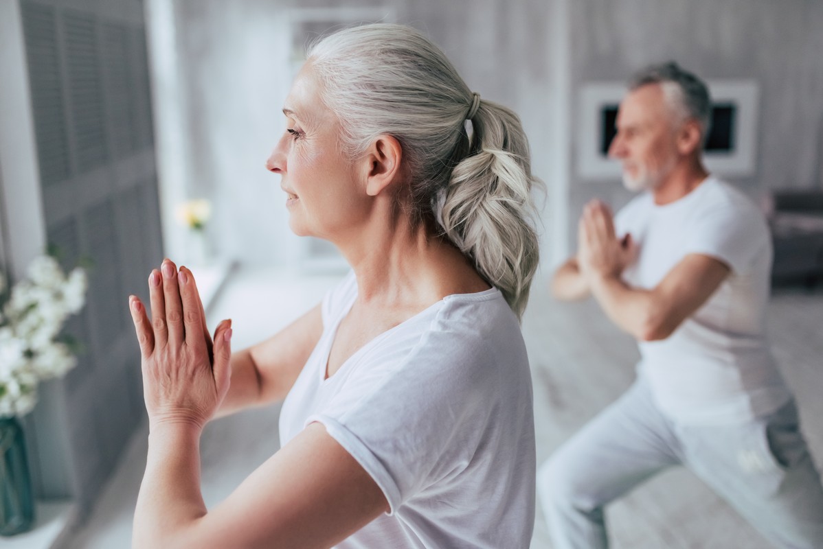 senior couple is doing fitness training at home