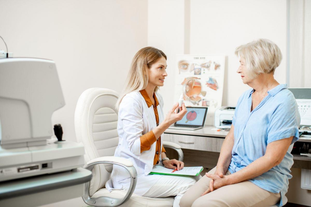 Senior woman patient talking with female ophthalmologist