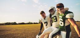 football-players-carrying-an-injured-teammate-off-the-field