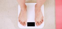 person-standing-on-white-scale