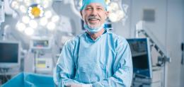 professional-surgeon-looking-into-camera-and-smiling