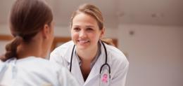 smiling-doctor-looking-at-a-patient-on-a-wheelchair