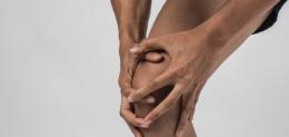 young-sport-man-with-strong-athletic-legs-holding-knee-with-his-hands-pain-after-suffering-ligament-injury-isolated-white_1150-2939