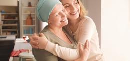 young-woman-visiting-her-mother-with-cancer-indoors