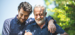 senior-father-and-adult-son-are-hugging-together