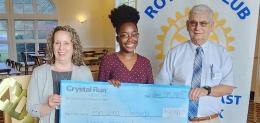 Wallkill East Rotary scholarship winner holding large scholarship check between two presenters