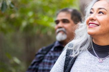 Mature woman hiking outdoors while smiling
