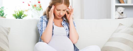 pregnant-woman-with-a-headache-and-pain