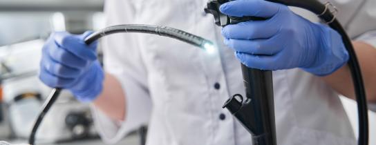 Healthcare provider holding endoscopy equipment
