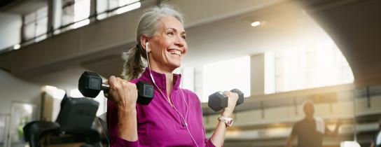 Woman lifting hand weights in a gym