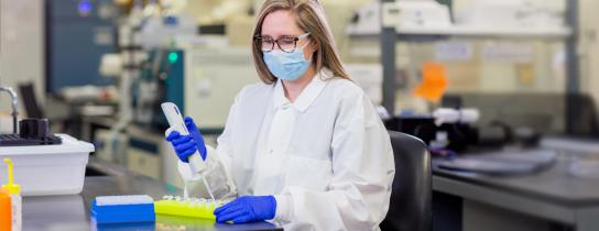 Pathologist in lab with specimens