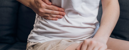 young-female-with-fatty-liver-touches-right-side-with-hand