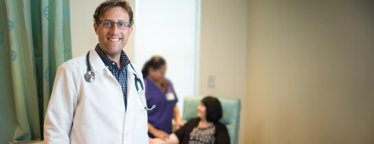 Dr. Rappaport, Oncologist smiling with patient in background