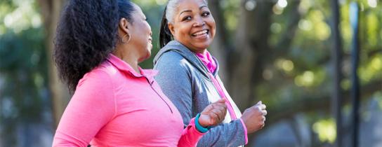 A pair of friends enjoy a vigorous outdoor walk