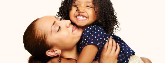 A mother holds her daughter aloft