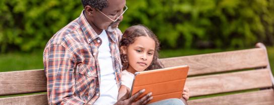 man and girl reading book