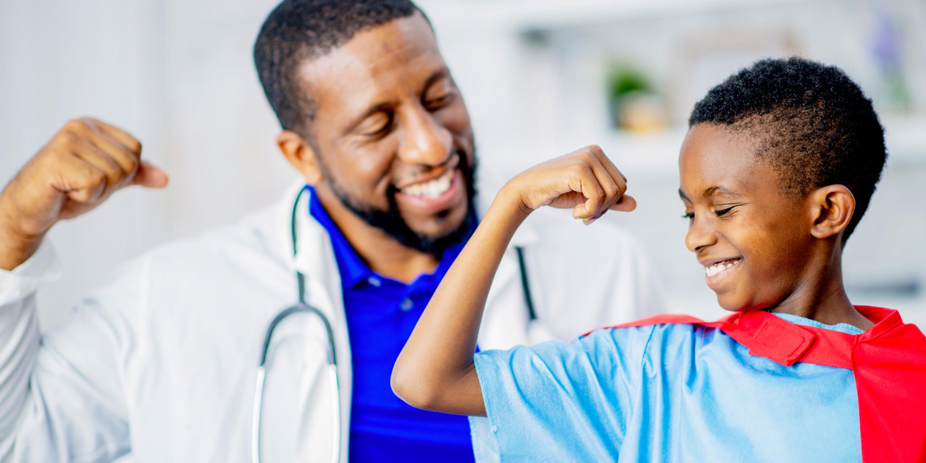 doctor and boy flexing arms