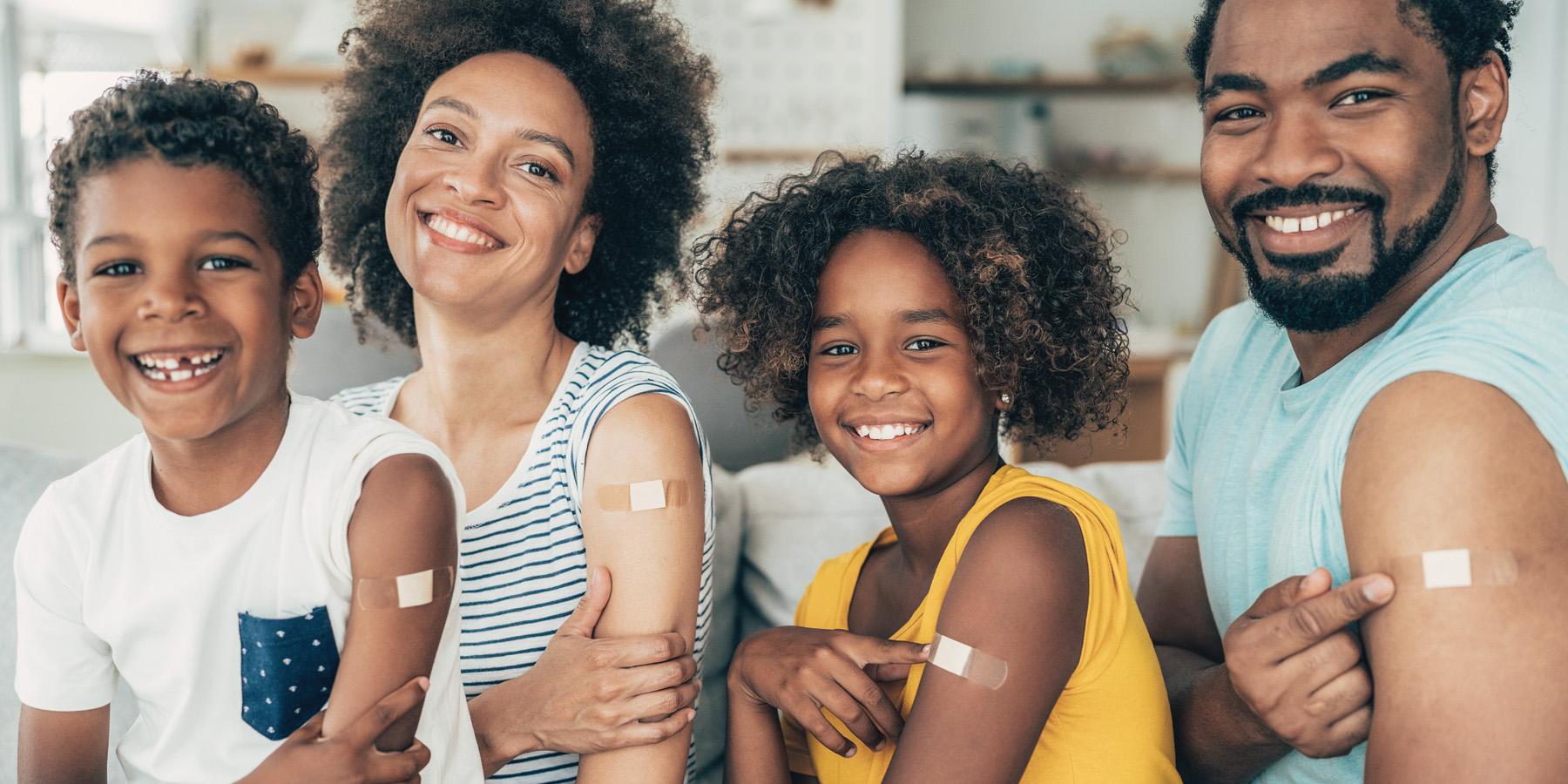 Family with bandaids on arms after flu shot
