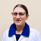 A photo of Abigail Ducheine, MD smiling in a lab coat