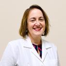 A photo of Mary Ellen King, DO smiling in a lab coat