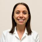 A photo of Corrin Lumbrazo, PA smiling in a lab coat