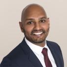 A photo of Kishan Patel, DO smiling in a suit