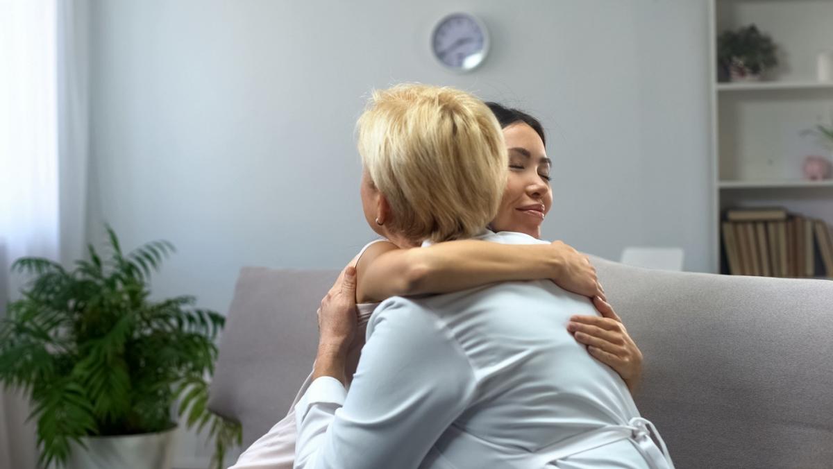 thankful girl hugging female doctor