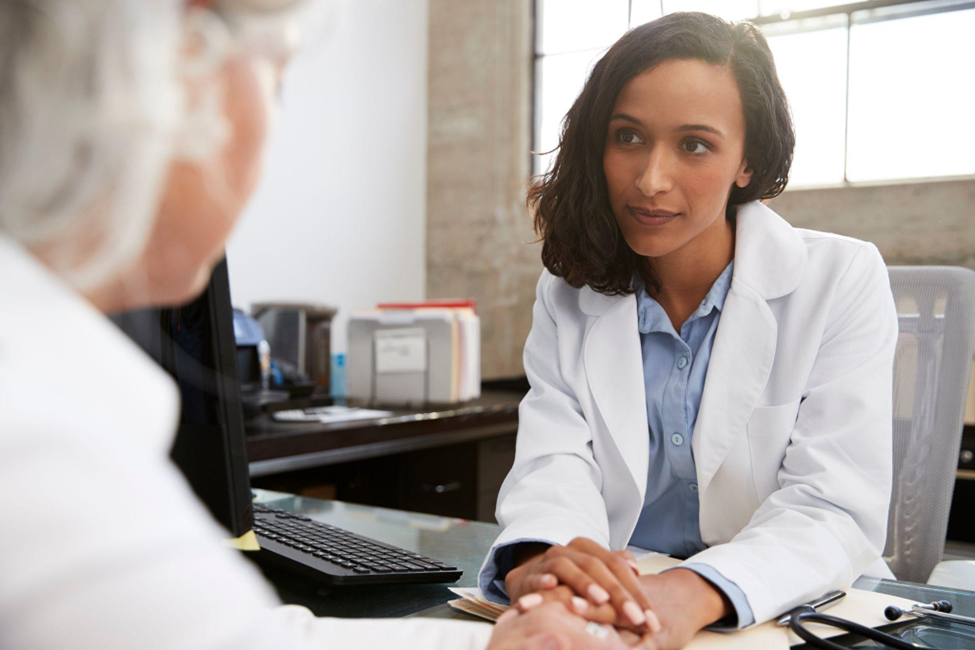 Young female doctor in consultation with senior patient